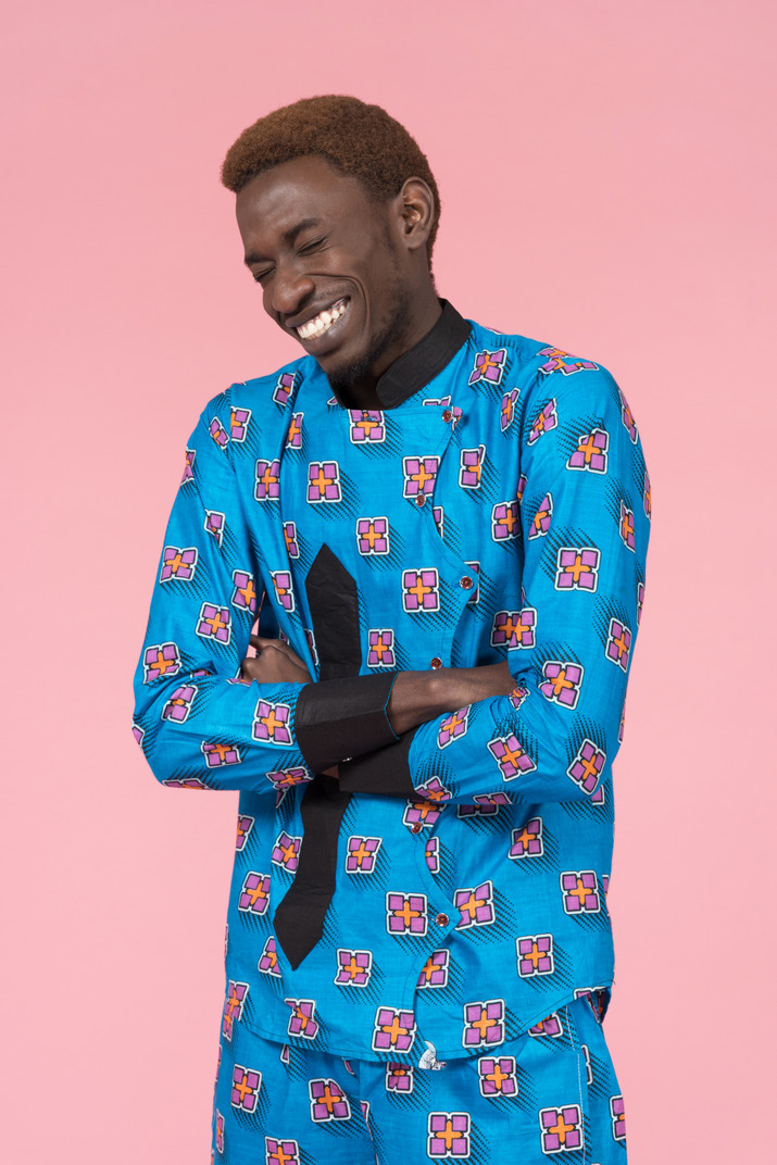 Black man in blue pajamas laughing