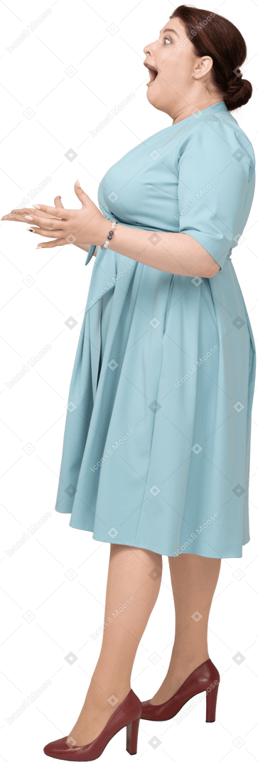Side view of an impressed woman in blue dress