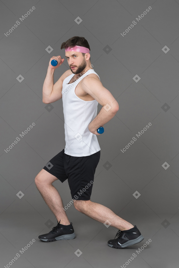 Young man working out with dumbbells