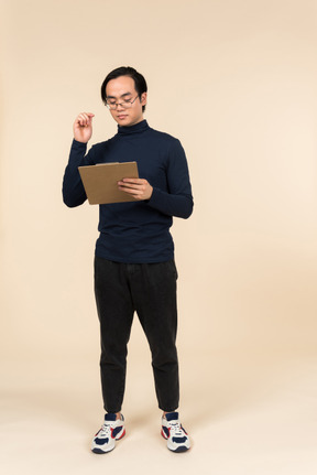 Young asian man holding a clipboard