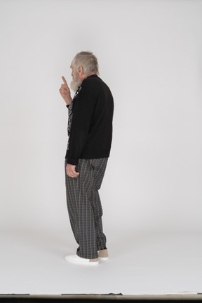 Back view of old man scolding with finger