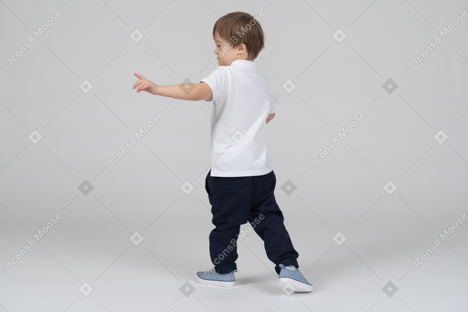 Little boy turning to point left