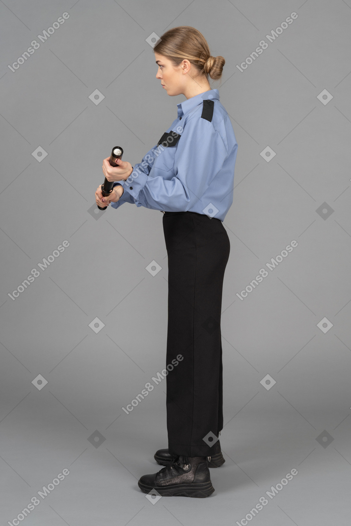 Female security guard with a baton in hands