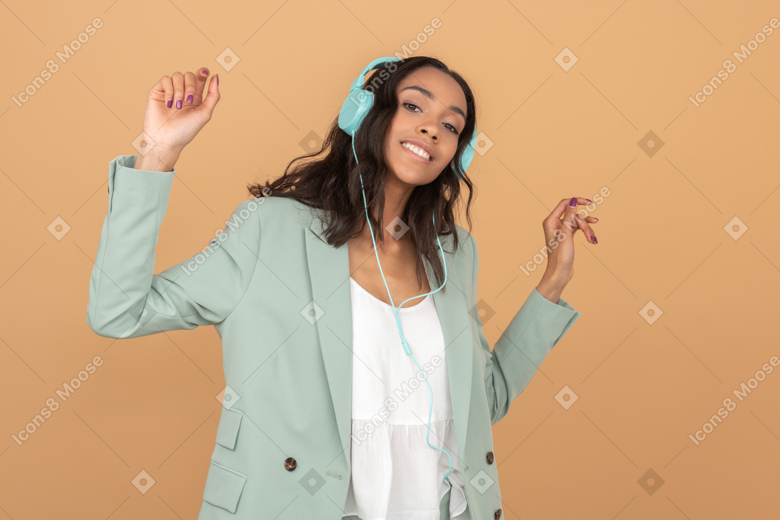 Attractive young girl listening to music and holding her hands up