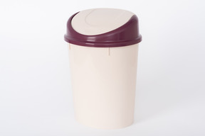 Brown plastic trash bin on white background