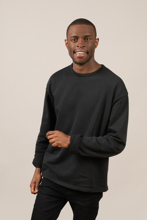 Young guy in black outfit smiling at camera