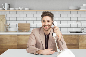 A man sitting at a table with a phone in his hand