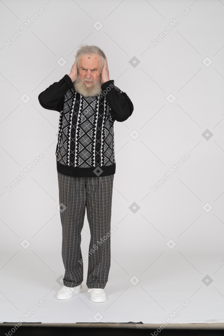 Old man covering ears