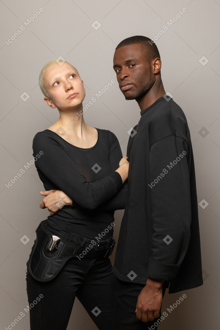 Young man standing with a woman and looking at camera