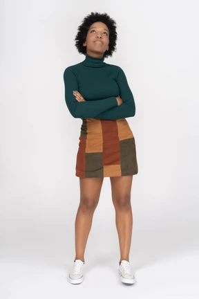 A woman standing with her arms crossed