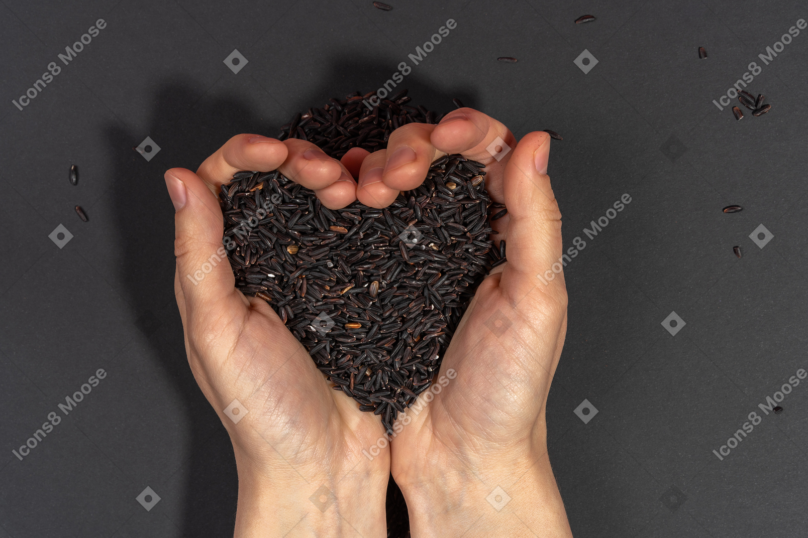 Heart shaped handful of black rice