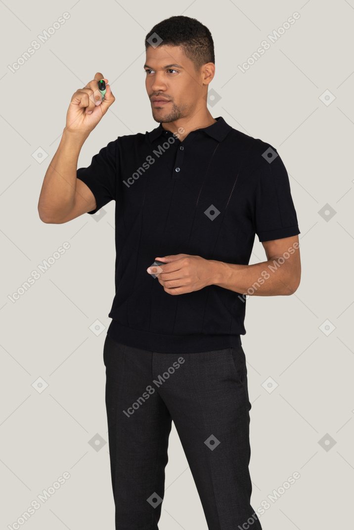 Man in black pants and t-shirt writing something with the marker