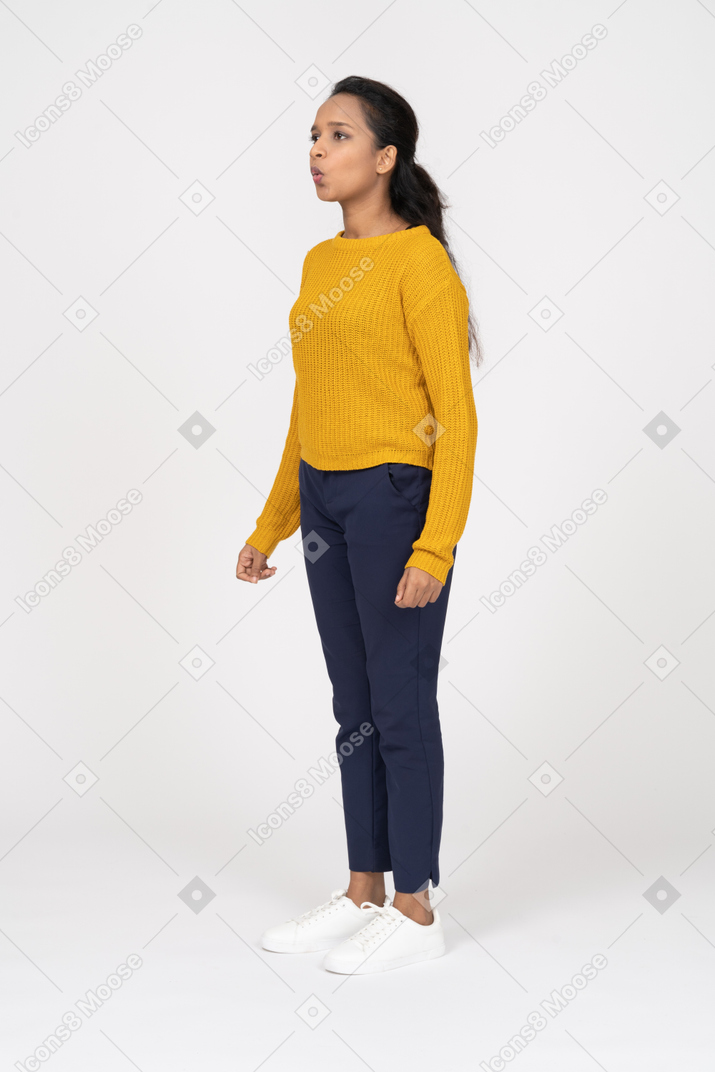 Side view of a girl in casual clothes whistling