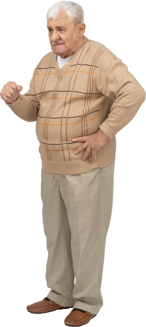腰に手を置いて立っているカジュアルな服装の老人の正面図