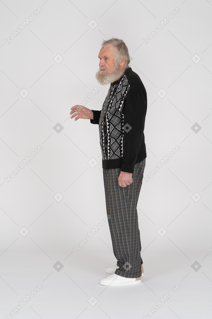 Side view of a standing elderly man raising his hand