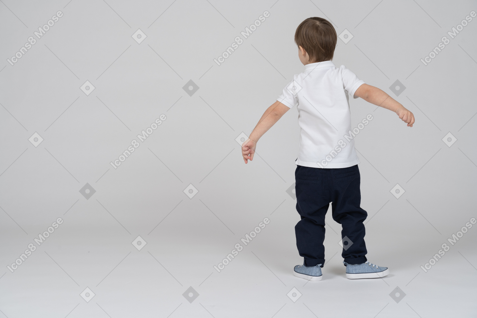 Back view of little boy swinging his arms