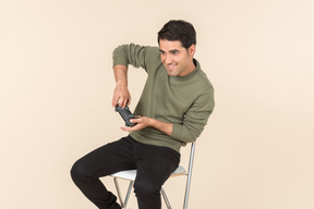 Young caucasian guy playing a videogame