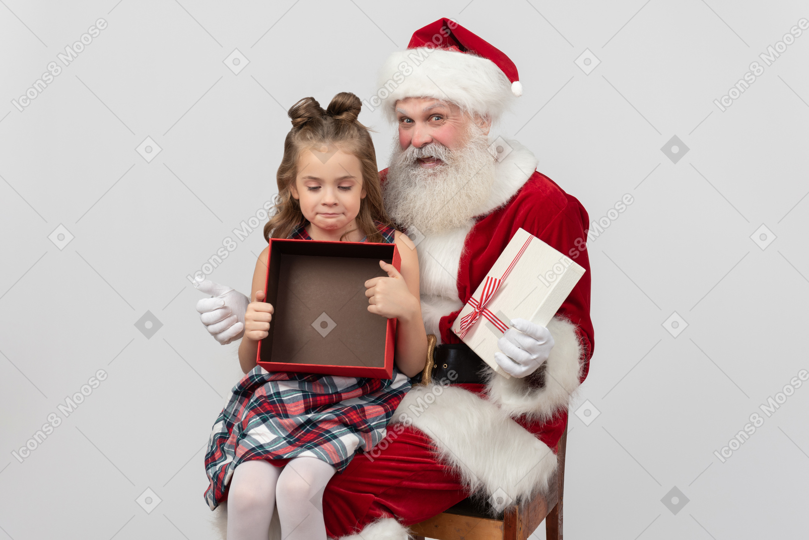 Sad kid girl holding empty gift box and santa looks happy 'cause of it