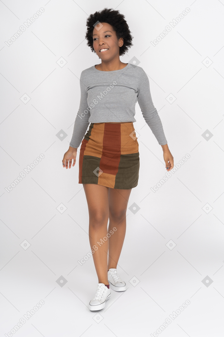 Cheerful african girl walking toward a camera