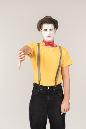 Sad looking male clown showing thumb down