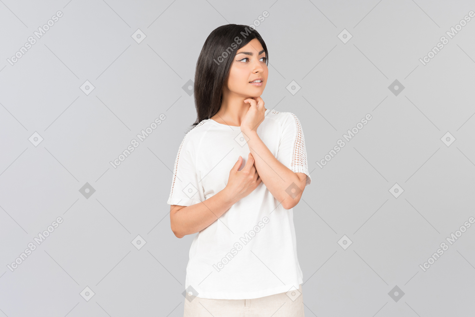 Dreamy young indian woman standing in comfy clothes
