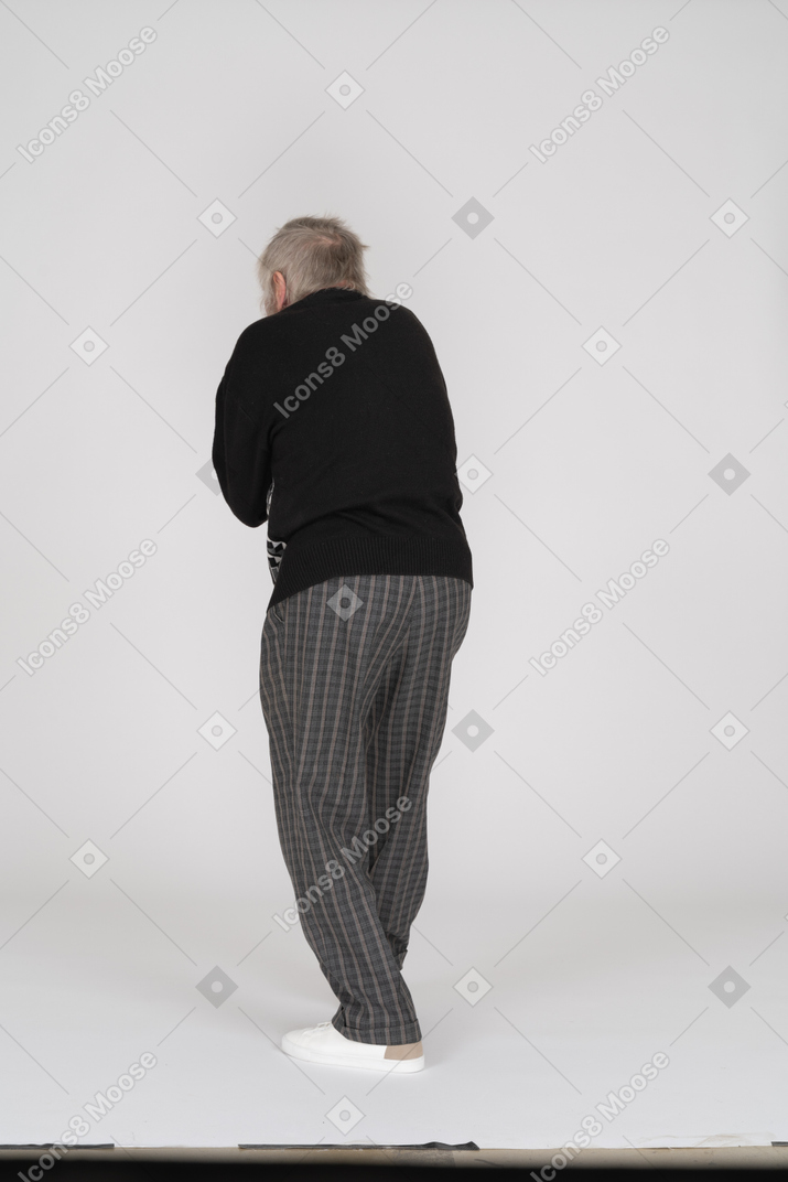 Back view of a senior man leaning forward