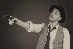 Gangster pointing a gun sideways