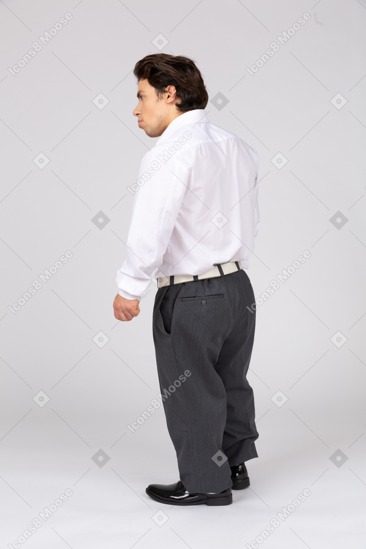 Three-quarter back view of an office worker in business casual clothes