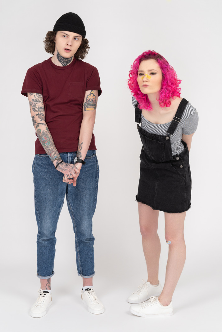 Full-length picture of a couple looking aside