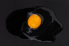 Shell-less egg on black background