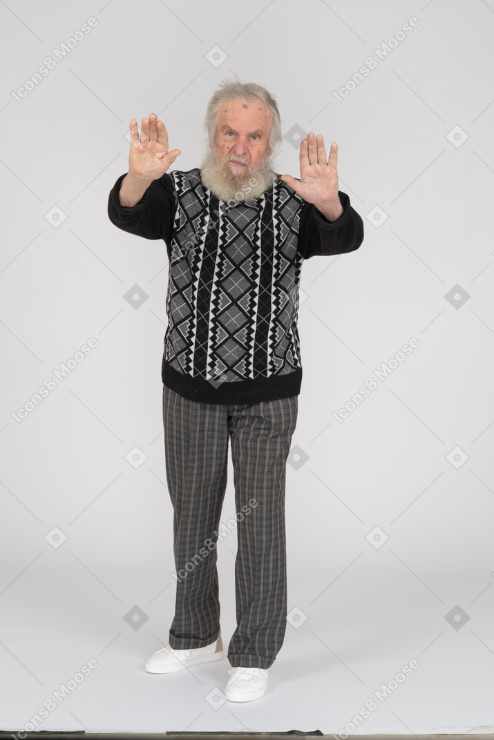 Old man stopping with hands