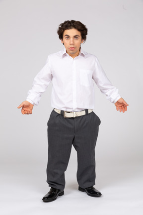 Young man talking and spreading arms