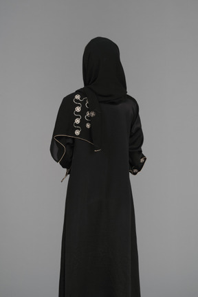 Muslim woman standing back to camera