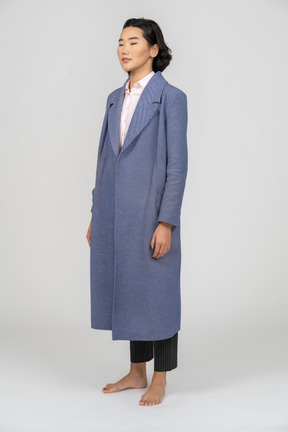 Woman in blue coat with eyes closed