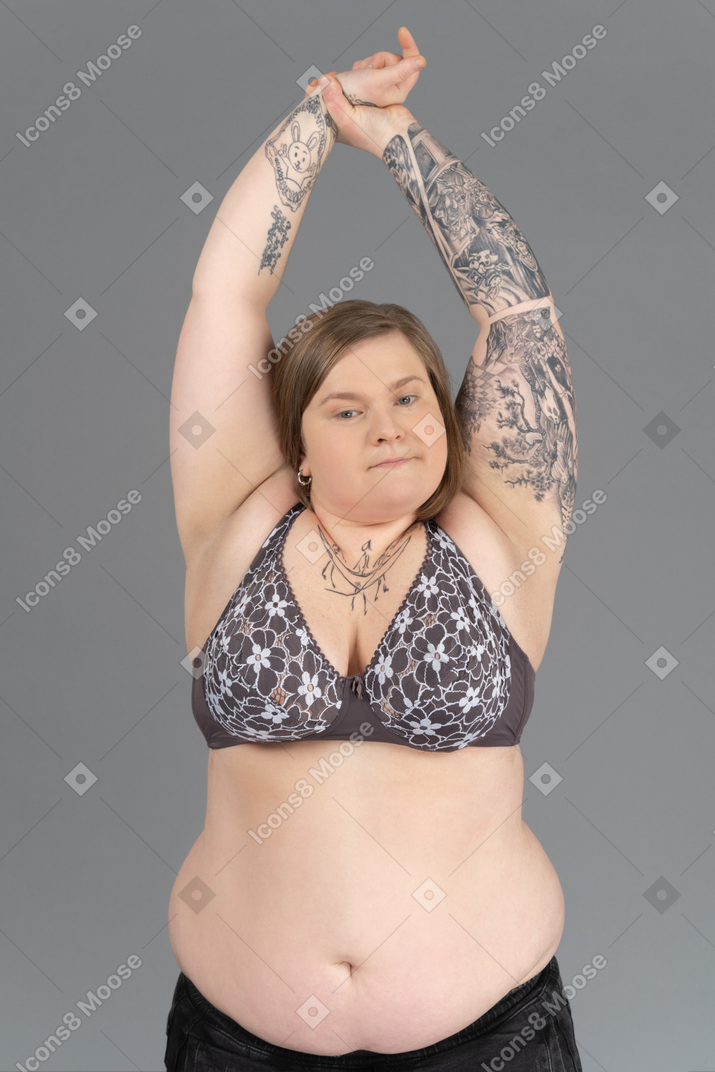 Plump woman putting hands up