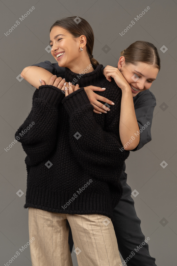 Women embracing and laughing