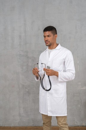 Male doctor holding a stethoscope