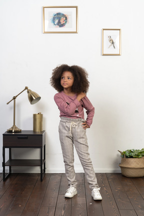 Cute girl kid posing on the apartments background