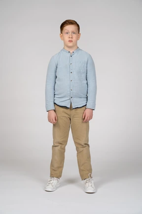 Boy in casual clothes making faces and looking at camera