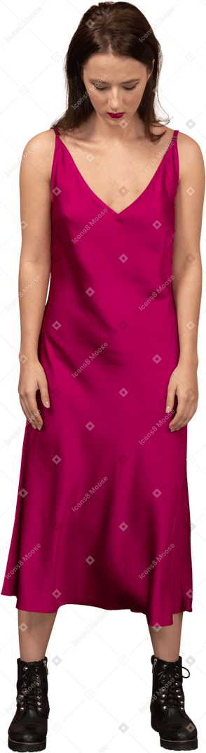 Front view of a beautiful young woman in red dress looking down