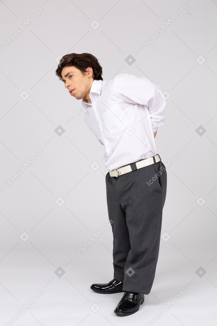 Man suffering from pain in back and bending down