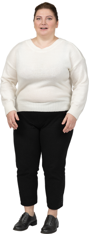 Happy plump woman in white sweater looking at camera