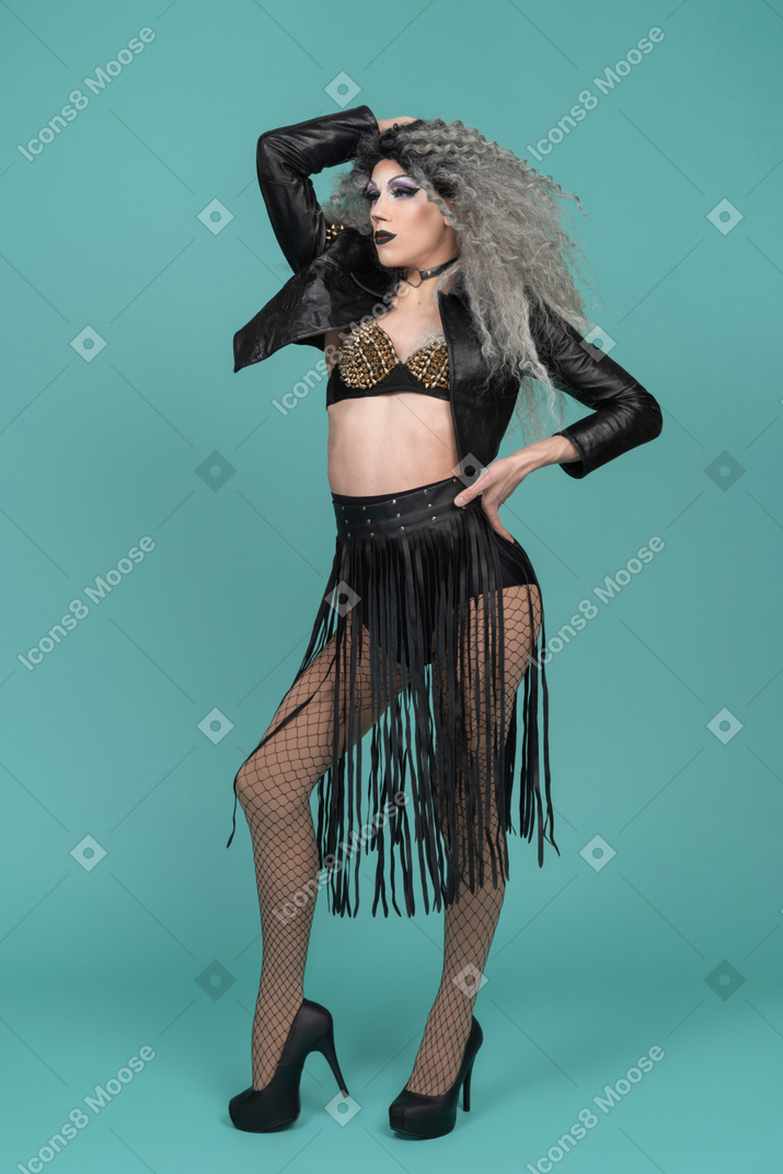 Drag queen in black leather jacket posing with hand on hip
