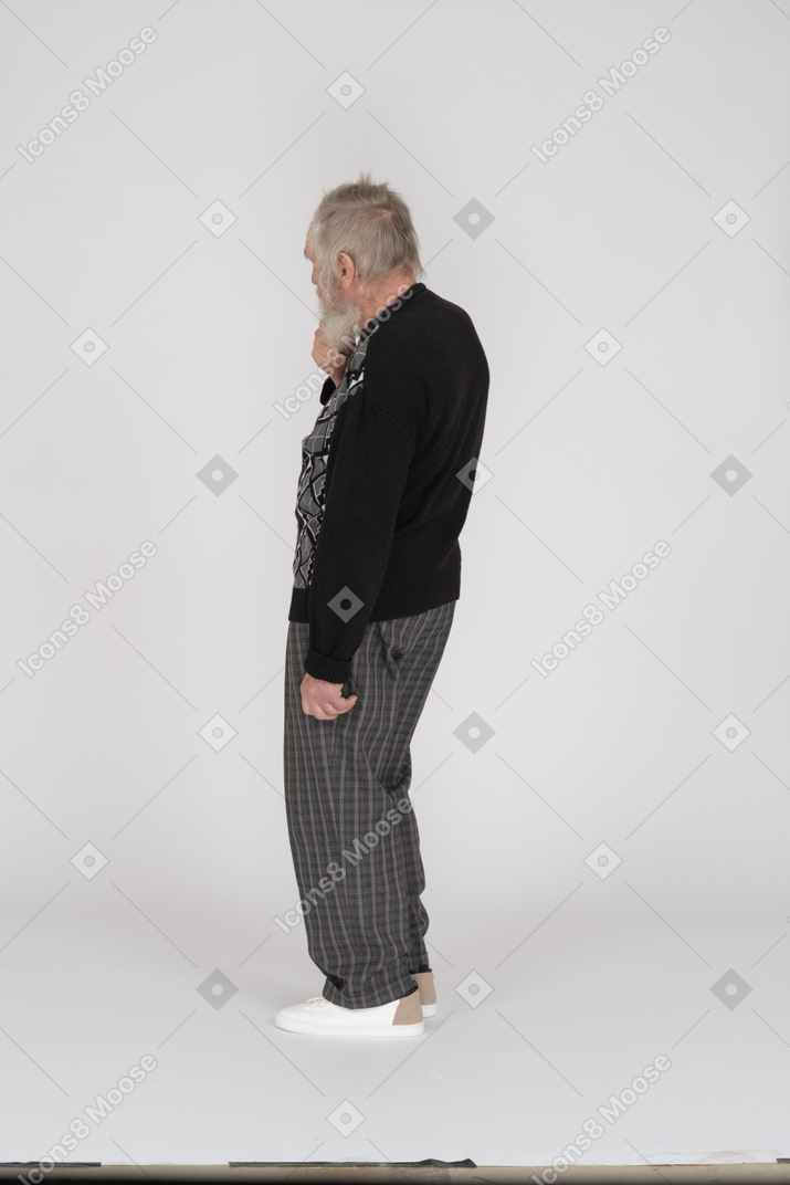 Thoughtful elderly man facing away from the camera
