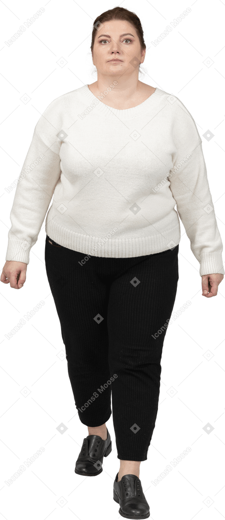 Front view of a plump woman in casual clothes looking at camera