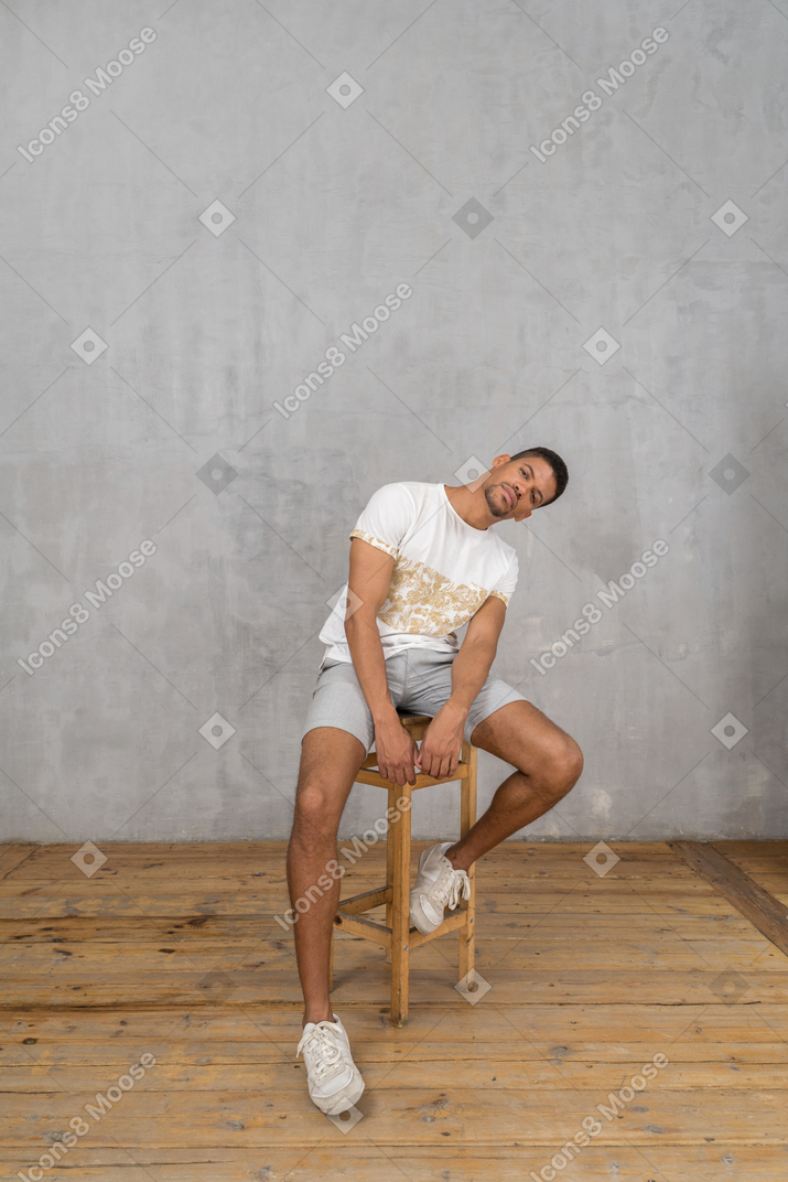 Man sitting on chair and bending sideways