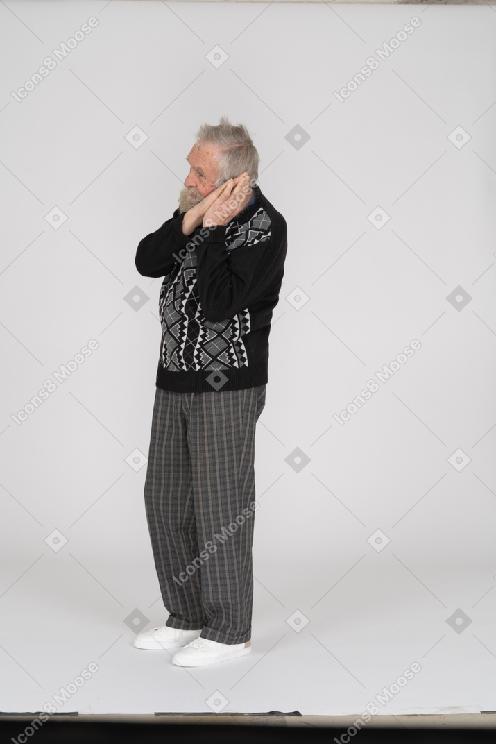 Old man showing sleep gesture