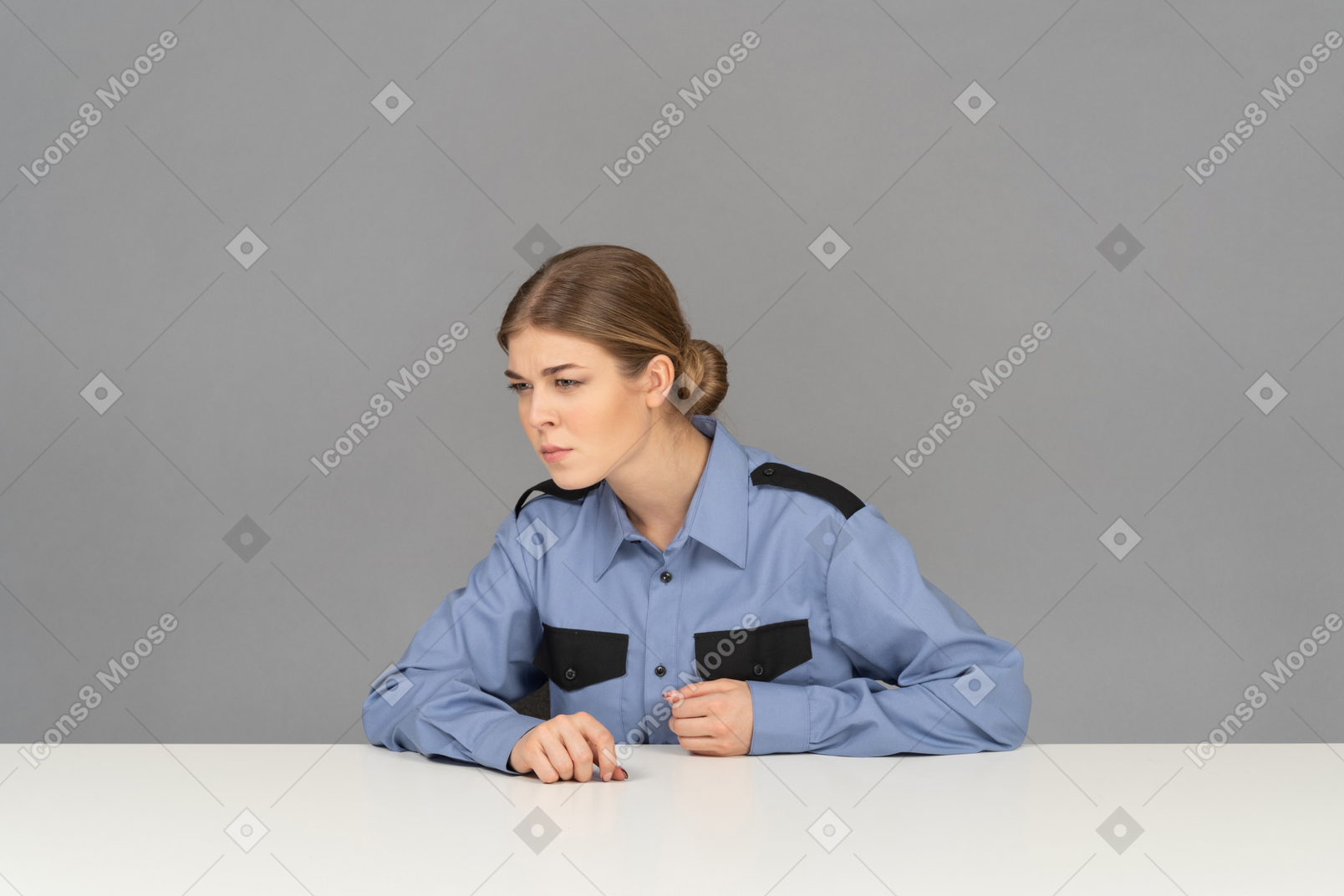 A female security guard looking sideways attentively
