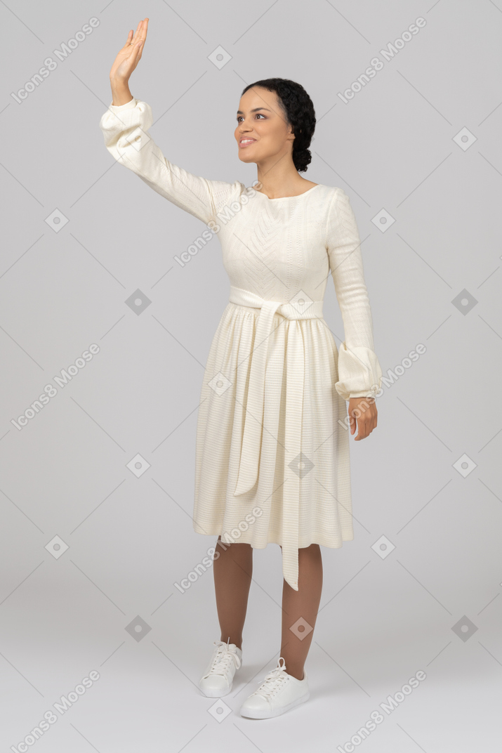 Cheerful young woman making a hello gesture