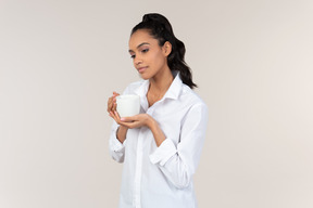 Young black woman in a white shirt doing her morning routine